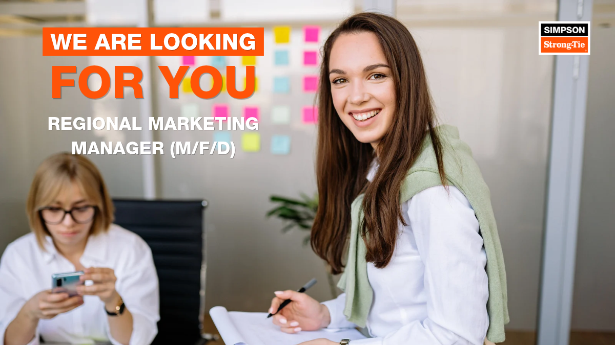 woman smiling in the camera while taking notes